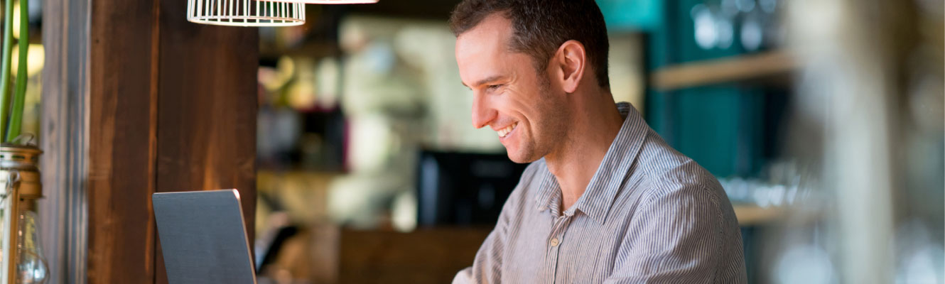 Man using computer in restaurant